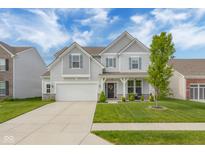Charming two-story home with a well-manicured lawn and inviting front porch at 2396 Creek Bank Dr, Columbus, IN 47201