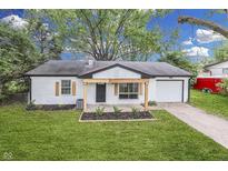 Charming, renovated single-story home boasts a freshly painted exterior and well-manicured lawn at 2706 Shakespeare Dr, Indianapolis, IN 46227