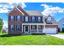 Two-story brick home featuring a welcoming front porch and a two-car garage with ample lawn space at 3101 Woodhaven Way, Bargersville, IN 46106