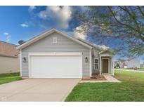 Charming single-story home with a gray exterior, a well-manicured lawn, and attached garage at 3367 Rolling Knoll Ln, Columbus, IN 47201