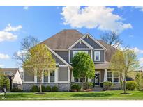 Charming two-story home with gray siding, stone accents, well-manicured lawn, and a welcoming front porch at 3561 Shady Lk Dr, Westfield, IN 46074