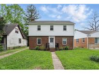 Charming two-story home featuring a brick and white facade with a well-maintained front yard at 4730 Rookwood Ave, Indianapolis, IN 46208