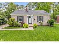 Charming single-story home featuring neutral paint, black shutters, manicured lawn, and tidy landscaping at 5526 Indianola Ave, Indianapolis, IN 46220