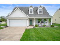 Charming home features a well-manicured lawn, two-car garage, and inviting front porch at 610 Redwood Dr, Pendleton, IN 46064