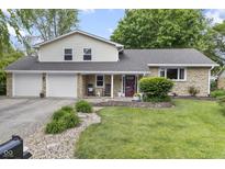 Charming home featuring a stone facade, a two-car garage, and a well-manicured front yard at 6288 Buttonwood Dr, Noblesville, IN 46062