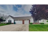 Charming exterior elevation of a two-car garage home with brick accents and well-manicured landscaping at 7018 Mallard Way, Plainfield, IN 46168