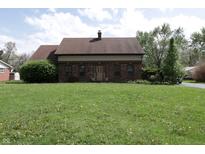 Charming brick home with a well-manicured lawn and inviting front entrance at 9903 E Raymond St, Indianapolis, IN 46239