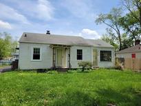 Charming single-story home with a well-manicured lawn and inviting front porch at 1507 N Luett Ave, Indianapolis, IN 46222