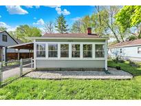 The sunroom offers lots of natural light with windows surrounding three sides of the room at 1523 E Perry St, Indianapolis, IN 46227