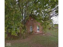 Quaint brick home with mature trees, offering privacy and charm at 15490 W 700 S, Anderson, IN 46017