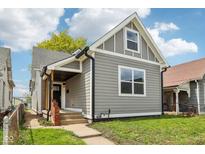 Charming gray home with a well-maintained lawn and inviting front porch at 202 Mckim Ave, Indianapolis, IN 46201