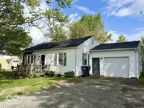 Charming single-story home with attached garage and a cozy front porch at 212 Vasbinder Dr, Chesterfield, IN 46017