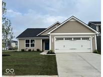 Charming single-story home featuring a two-car garage, a blue door, and a well-manicured front lawn at 2334 Black Rock Cir, Lebanon, IN 46052