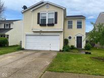 Charming two-story home featuring a two-car garage, lovely front yard, and welcoming curb appeal at 2350 Harvest Moon Dr, Greenwood, IN 46143