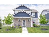 Charming two-story home with a stone facade, well-manicured lawn, and inviting front porch at 2628 Lamar Dr, Whitestown, IN 46075