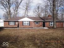 Charming single-story brick home featuring black shutters and freshly mulched landscaping at 3008 W Grace Ln, Muncie, IN 47304