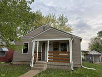 Charming single-story home with covered front porch and neutral siding at 357 N 18Th Ave, Beech Grove, IN 46107
