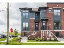 Modern townhome with red brick, gray siding, multiple windows, and landscaped front yard at 401 Jersey St, Westfield, IN 46074