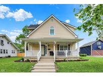 Charming two-story home with a welcoming front porch and landscaped yard at 410 E North St, Greenfield, IN 46140
