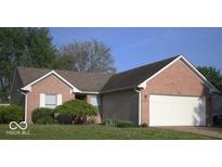 Charming single-story home featuring a brick facade, attached two-car garage, and a well-manicured front lawn at 4195 Knollwood Ct, Franklin, IN 46131
