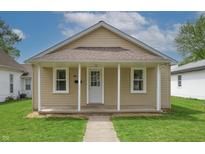 Charming single-story home with neutral siding, front porch and well-maintained lawn at 52 N Ross St, Columbus, IN 47201