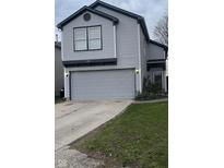 Charming two-story home with a gray vinyl siding and a two car garage at 562 Harmony Dr, Greenwood, IN 46143