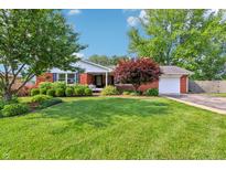 Charming brick home featuring a well-manicured lawn and lush landscaping at 5987 E 100 N, Franklin, IN 46131