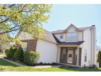 Charming two-story home with a combination of brick and white siding and a well-manicured lawn at 9718 Jupiter Pass, Carmel, IN 46032