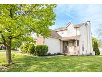 Charming two-story home with a brick facade, well-maintained lawn, and beautiful landscaping at 9718 Jupiter Pass, Carmel, IN 46032