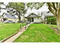 Charming single-story home with inviting front porch and well-maintained lawn at 1014 W 32Nd St, Indianapolis, IN 46208