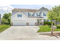 Charming two-story home with a well-manicured lawn, two-car garage, and a welcoming front entrance at 11121 Godfrey Dr, Noblesville, IN 46060