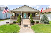 Charming home featuring a welcoming front porch, well-maintained lawn, and tidy landscaping at 1426 S Anderson St, Elwood, IN 46036