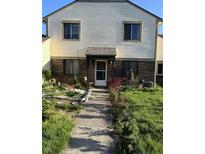 Charming home exterior with brick accents and lush greenery in the front yard at 4984 W 59Th St, Indianapolis, IN 46254