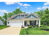 Charming two-story home with a well-manicured lawn and inviting front porch with beautiful curb appeal at 5580 Pintail Ln, Greenwood, IN 46143
