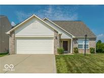 Charming home featuring a two-car garage, brick accents, well-manicured lawn and welcoming front porch at 5708 Outer Bank Rd, Indianapolis, IN 46239