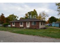 Charming one-story brick home with well-maintained lawn and landscaping under cloudy skies at 5979 S Walcott St, Indianapolis, IN 46227