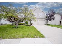 Charming two-story home with a well-manicured lawn and attached two car garage in a suburban neighborhood at 6270 Lancaster Pl, Zionsville, IN 46077