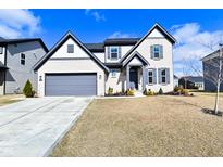 Charming two-story home with a gray garage, gray shutters and a manicured front yard at 9928 Deep Royal Way, Indianapolis, IN 46239