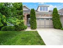 Charming home featuring a stone facade, manicured lawn, and mature trees enhancing curb appeal at 127 Coatsville Dr, Westfield, IN 46074