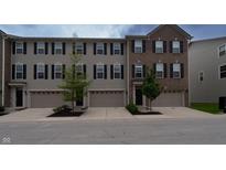 Attractive townhome exterior featuring a well maintained lawn and a two car garage at 14226 Frostburg Dr, Carmel, IN 46033