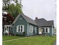 Charming two-story home with light blue siding, white trim, and a well-manicured front lawn at 1567 Logan St, Noblesville, IN 46060
