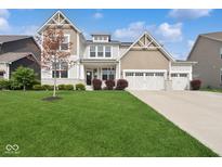 Beautiful two-story home with a well-manicured lawn and three car garage at 16264 Red Clover Ln, Noblesville, IN 46062