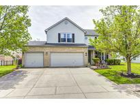 Charming two-story home features a spacious three-car garage and a well-maintained front yard at 1831 Whisperwood Trl, Danville, IN 46122