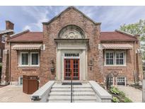 Charming brick building featuring a red door and decorative architectural details, creating an inviting and historical facade at 196 E Madison St, Franklin, IN 46131