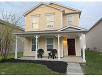 Charming two-story home featuring a welcoming front porch, manicured lawn, and inviting curb appeal at 2327 Bristol Dr, Franklin, IN 46131