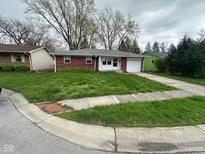 Charming single-story home with a brick exterior and a well-maintained front yard on a cloudy day at 2453 Larnie Ln, Indianapolis, IN 46219