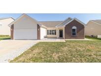 Charming single-story home with a brick and vinyl exterior and attached garage at 2761 Winding Creek Ln, Greenfield, IN 46140