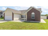 Charming single-Gathering home with a well-maintained lawn, brick accents, and a two-car garage at 2761 Winding Creek Ln, Greenfield, IN 46140