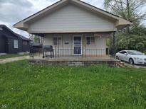 Charming single-Gathering home with a covered front porch and wrought-iron railing at 3031 E 38Th St, Indianapolis, IN 46218