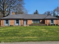 Charming single story brick home featuring a well-manicured front lawn and an inviting entrance at 3128 W 12Th St, Anderson, IN 46011